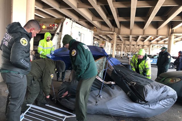 City workers cleared a homeless encampment under the BQE